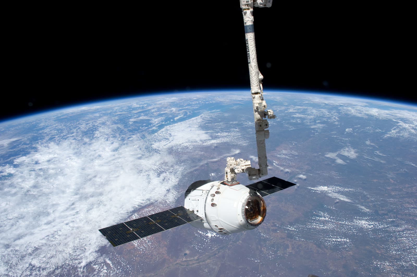 The first commercial spacecraft to visit the International Space Station, Dragon C2+, held by the station's robotic arm, May 25 2012