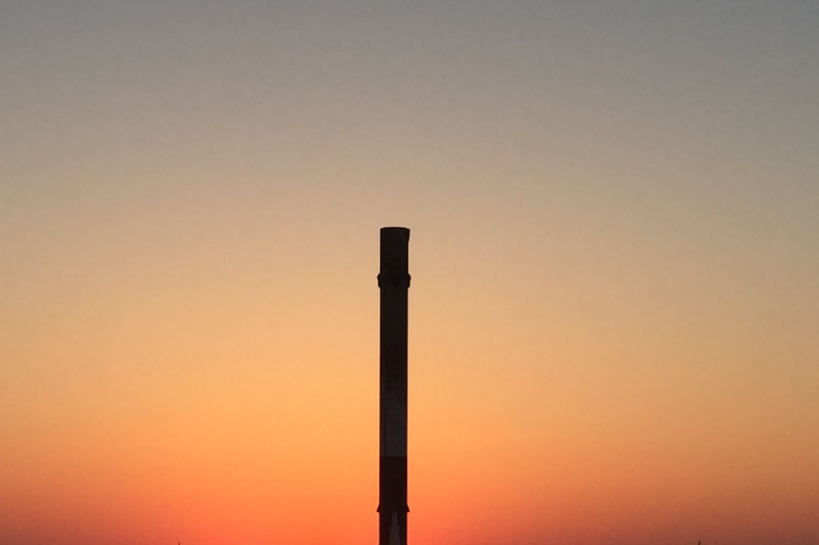 A recovered Falcon 9 first stage standing on the droneship deck