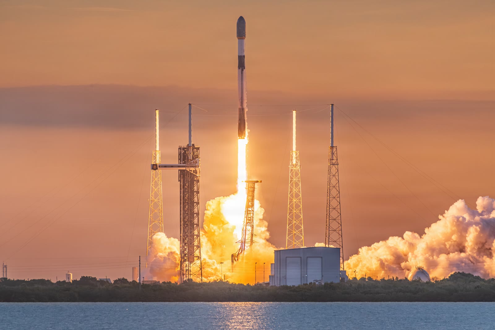 Falcon 9 climbing away from Space Launch Complex 40 at sunset on a Starlink mission