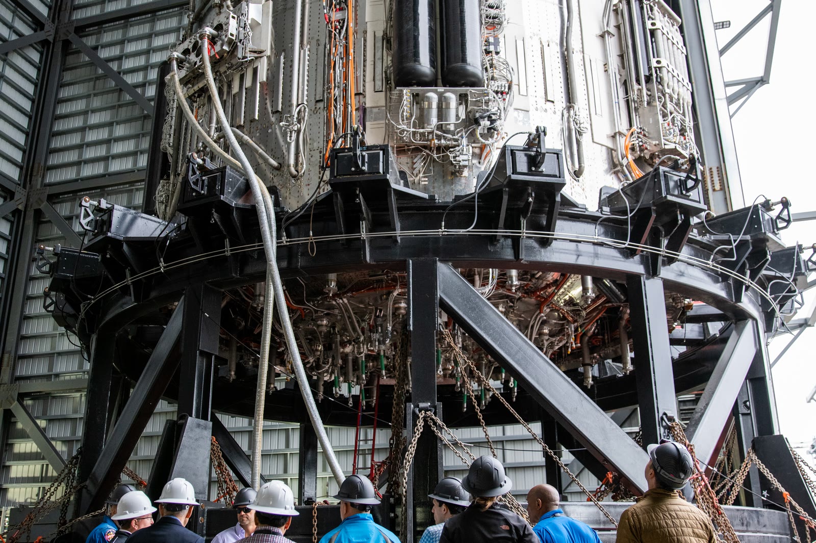 A Super Heavy booster standing at Starbase during a NASA visit