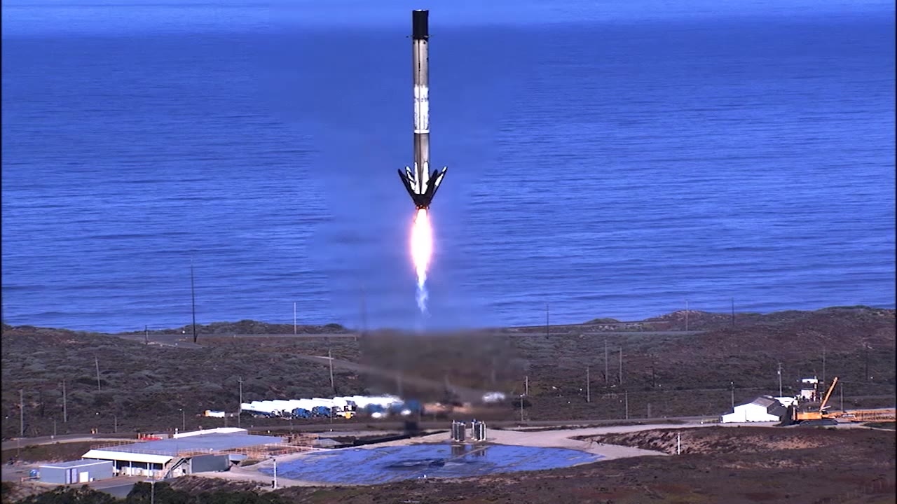 A Falcon 9 first stage descending on its landing burn and touching down beside the Pacific at Vandenberg, November 21 2020